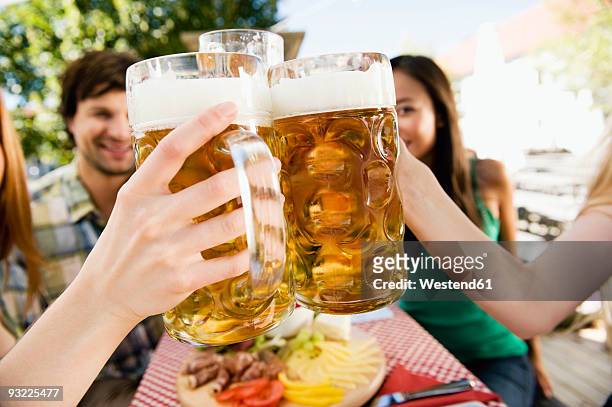 germany, bavaria, upper bavaria, young people in beer garden, close-up - boccale da birra di ceramica foto e immagini stock