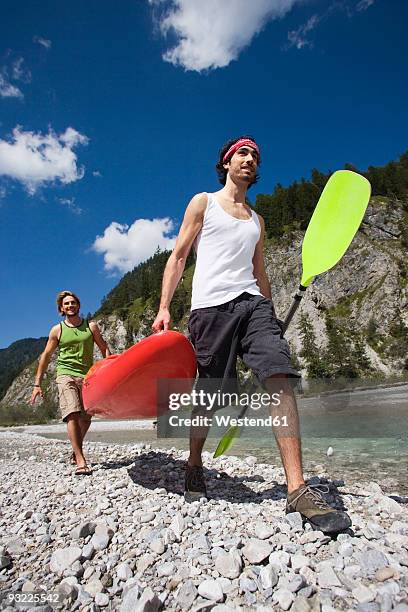 germany, bavaria, tölzer land, men carrying kajak - kajak photos et images de collection