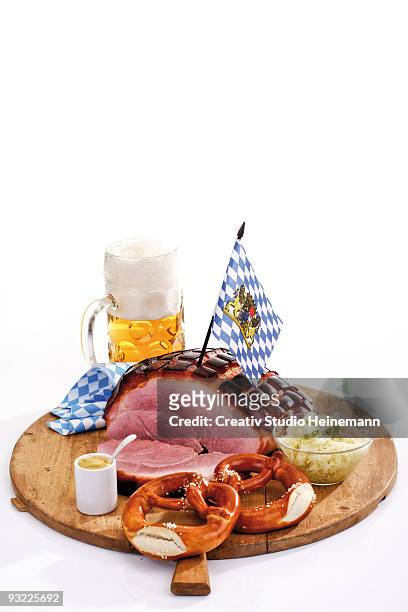roast pork with crackling, pretzels and a mug of beer on wooden board - crackling imagens e fotografias de stock