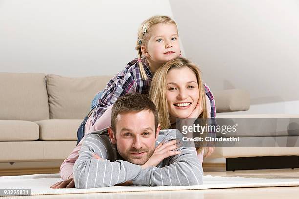 parents and daughter (3-4) relaxing at home - 2 year old blonde girl father stock pictures, royalty-free photos & images