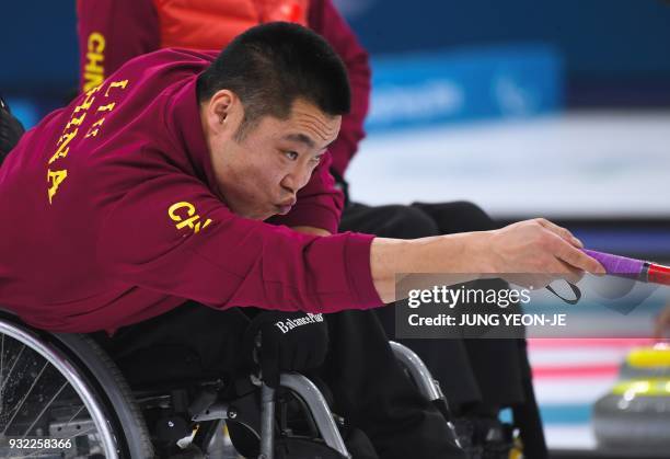 China's Liu Wei releases a stone during the wheelchair curling round robin session at the Gangneung Curling Centre during the Pyeongchang 2018 Winter...