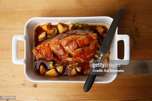 roast pork with crackling in roasting tin, elevated view - crackling stock pictures, royalty-free photos & images