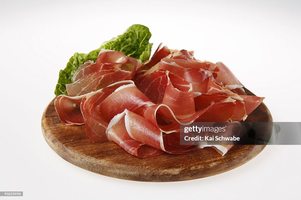 Sliced ham on wooden board