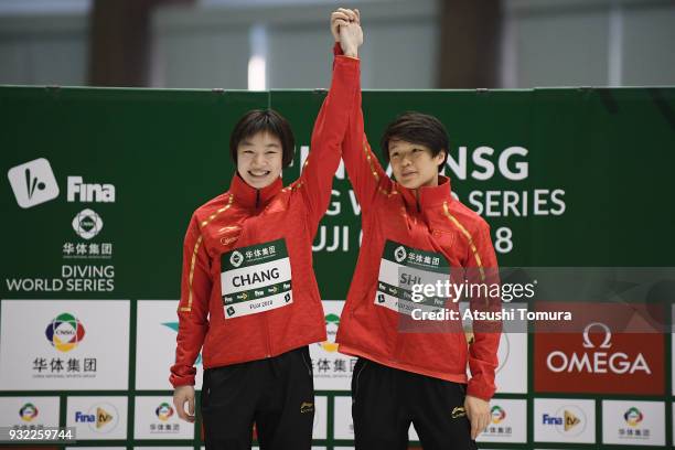 Yani Chang and Tingmao Shi of China celebrate on the podium after winning in the Women's 3m Synchro Platform final during day one of the FINA Diving...