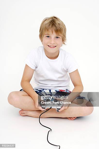 little boy (10-11) playing with paddle - boy 10 11 stock pictures, royalty-free photos & images