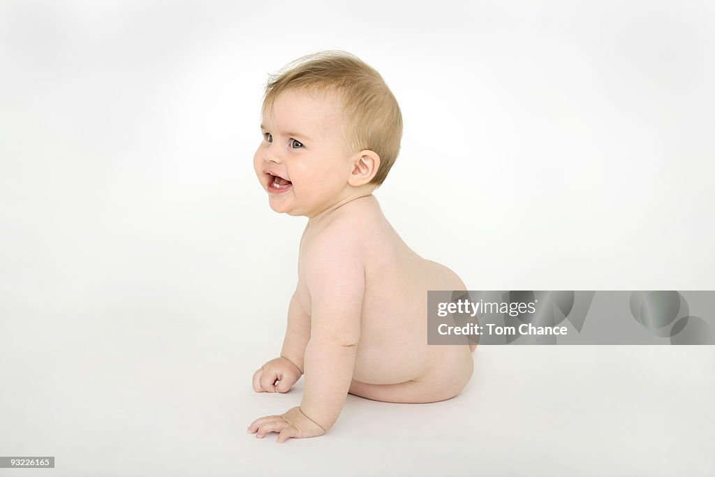 Baby girl (6-12 months) smiling, portrait