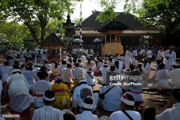 Balinese Hindus are conducting prayers at Petitenget beach on March 14, 2018 in Bali, Indonesia. The melasti ritual is aimed at self-purification...
