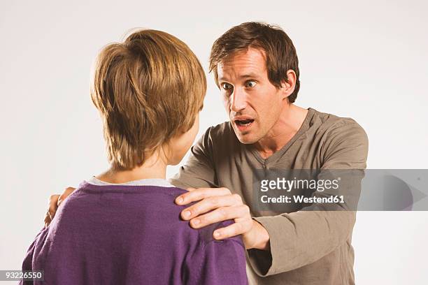 father and son (13-14), man looking frightened - child shock studio stock pictures, royalty-free photos & images