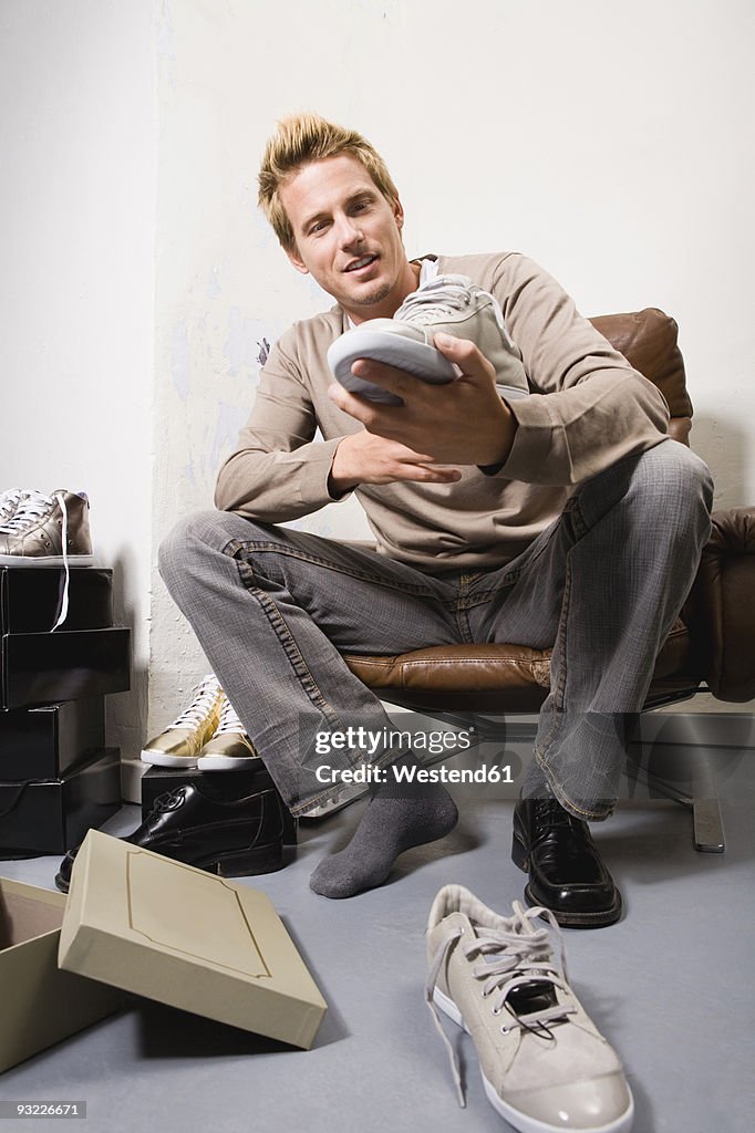 Young man in shoe store, trying on shoes