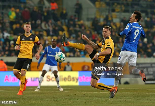 Florian Ballas of Dresden, Marcel Franke of Dresden and Dong-Won Ji of Darmstadt battle for the ball during the Second Bundesliga match between SG...