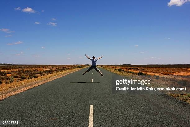 outback highway star jump - main road stock pictures, royalty-free photos & images