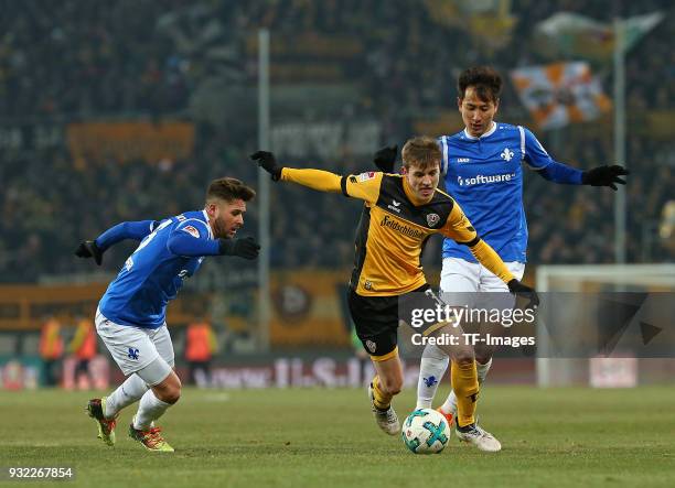 Markus Steinhoefer of Darmstadt, Niklas Hauptmann of Dresden and Dong-Won Ji of Darmstadt battle for the ball during the Second Bundesliga match...