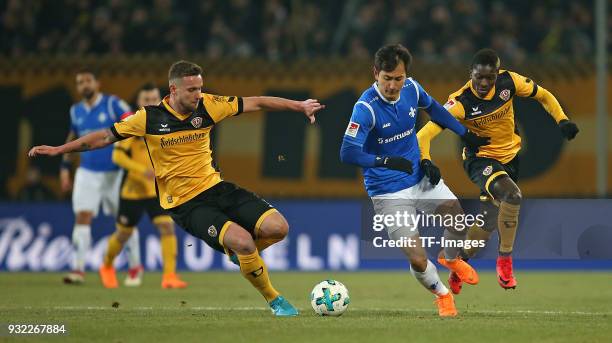 Manuel Konrad of Dresden, Dong-Won Ji of Darmstadt and Moussa Kone of Dresden battle for the ball during the Second Bundesliga match between SG...