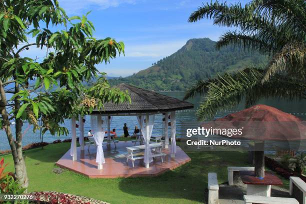 People relax enjoy the view of Lake Toba. Lake Toba is the largest volcanic lake in Southeast Asia. The lake is located in North Sumatra, Indonesia...
