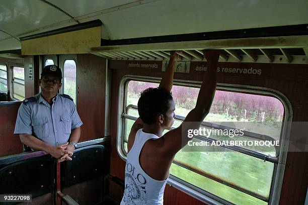 Guard of the Hershey's train waits for the next stop to open doors in Havana on November 17, 2009. In 1916 the Hershey Corporation of Pennsylvania...