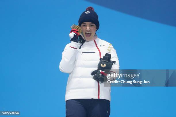 Gold medallist Marie Bochet of France celebrates on the podium during the medal ceremony for the Alpien Skiing Women's Gaint Slalom - Standing on day...