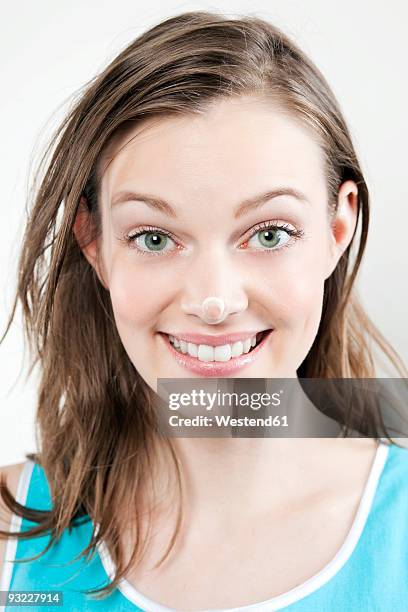 young woman with cream on her nose, smiling, portrait - 人間の鼻 ストックフォトと画像