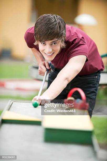 germany, bavaria, young man playing pool outside, portrait - bent golf club stock pictures, royalty-free photos & images