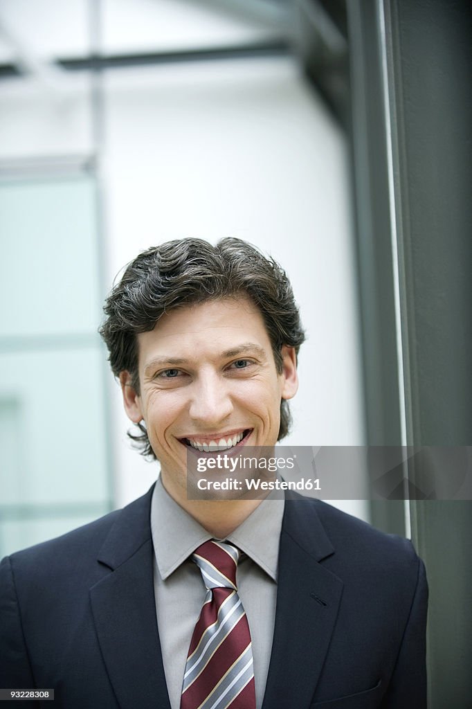 Germany, Munich, Businessman laughing, portrait