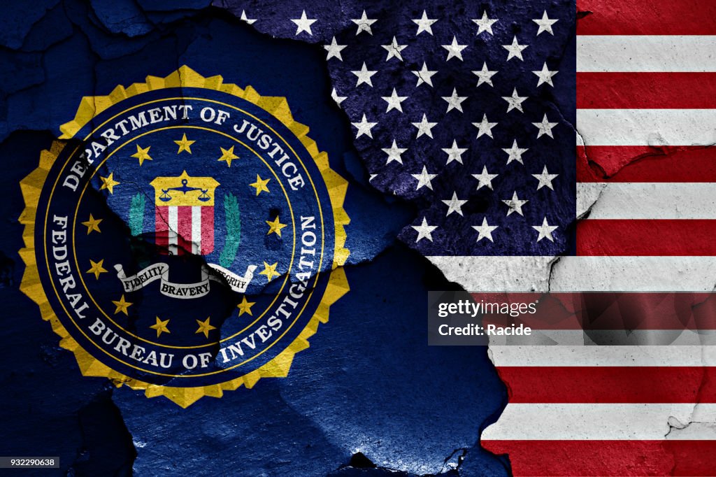 Flag of FBI and USA painted on cracked wall