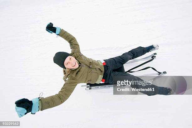 italy, south tyrol, seiseralm, girl (12-13) sledding downhill, portrait - 12 13 jaar stockfoto's en -beelden