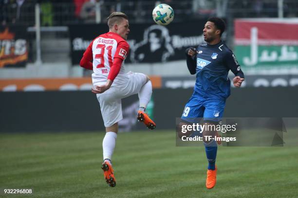 Philipp Max of Augsburg and Serge Gnabry of Hoffenheim battle for the ball during the Bundesliga match between FC Augsburg and TSG 1899 Hoffenheim at...