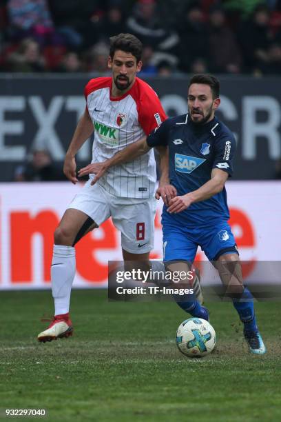 Rani Khedira of Augsburg and Lukas Rupp of Hoffenheim battle for the ball during the Bundesliga match between FC Augsburg and TSG 1899 Hoffenheim at...