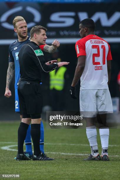 Kevin Vogt of Hoffenheim speaks with referee Patrick Ittrich and Sergio Cordova of Augsburg during the Bundesliga match between FC Augsburg and TSG...