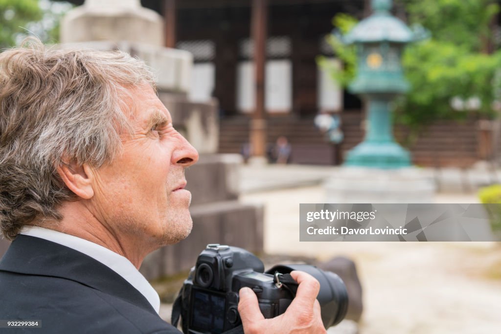Man with camera and Zen garden of Chion-ji temple in Kyoto, Japan