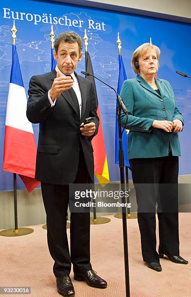 Nicolas Sarkozy, France's president, left and Angela Merkel, Germany's chancellor, hold a news conference during the European Union Summit at the EU...