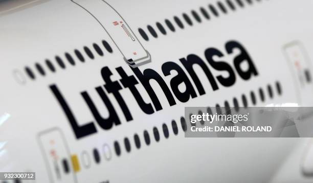 The name of German airline Lufthansa is pictured on a model airplane at the company's headquarters in Frankfurt am Main, western Germany, where the...