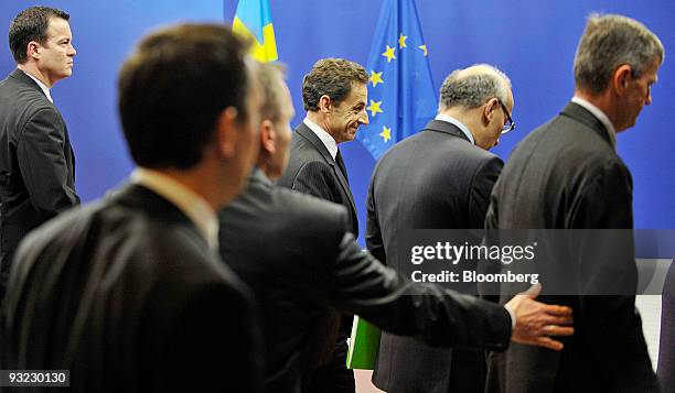 Nicolas Sarkozy, France's president, center, surrounded by staff and security, arrives for the European Union Summit at the EU headquarters in...