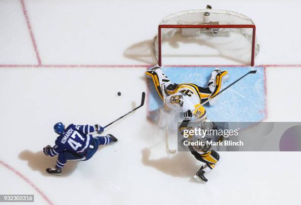 Leo Komarov of the Toronto Maple Leafs goes to the net against Tristan Jarry and Kris Letang of the Pittsburgh Penguins during the first period at...