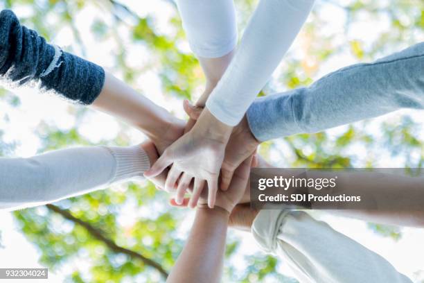 low angle view of community volunteers' hands - giving stock pictures, royalty-free photos & images