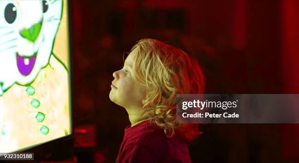 young child watching television - child animated watching stock-fotos und bilder