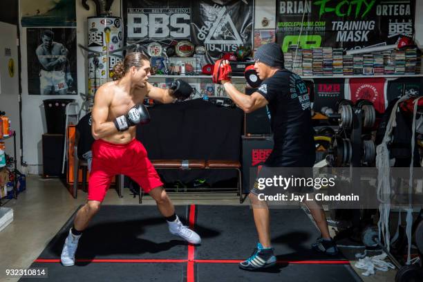 Brian "T-City" Ortega, a UFC featherweight fighter, trains in the garage of his coach, James Luhrsen, in the Harbor City neighborhood of Los Angeles,...