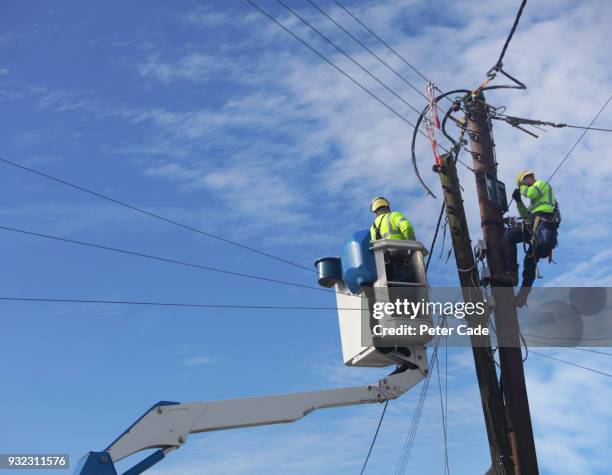 men up pole working on power lines - telecommunications stock pictures, royalty-free photos & images