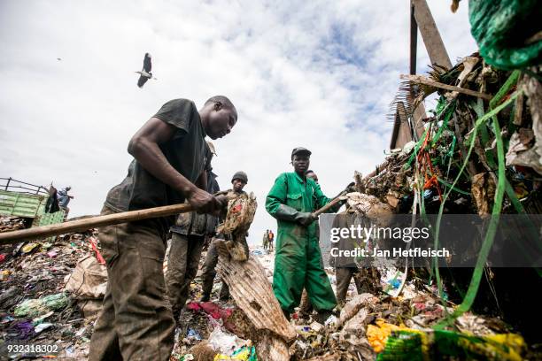 Men unload a truck at the Dandora rubbish dump on March 14, 2018 in Nairobi, Kenya. The Dandora landfield is located 8 Kilometer east of the city...