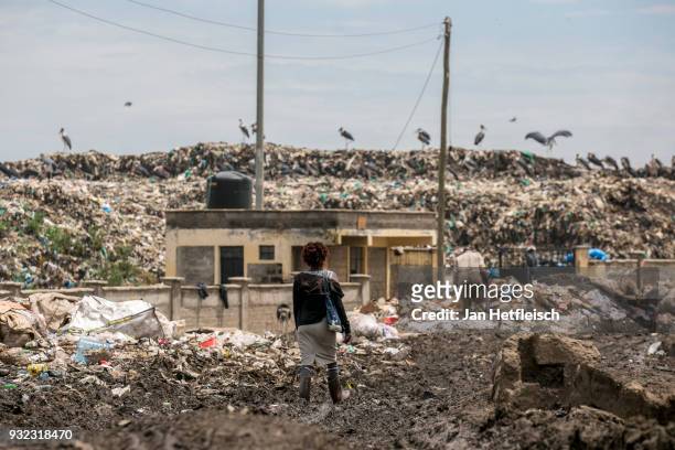 Woman walks to the Dandora rubbish dump on March 14, 2018 in Nairobi, Kenya. The Dandora landfield is located 8 Kilometer east of the city center of...
