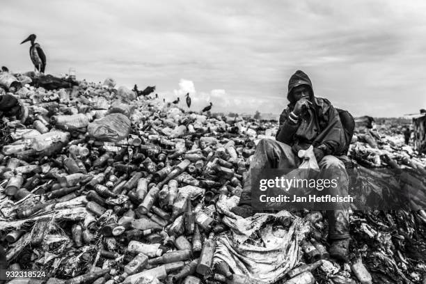 Man sits on the Dandora rubbish Dump on March 14, 2018 in Nairobi, Kenya. The Dandora landfield is located 8 Kilometer east of the city center of...