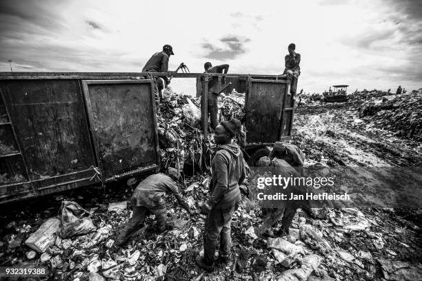 Men unload a truck at the Dandora rubbish dump on March 14, 2018 in Nairobi, Kenya. The Dandora landfield is located 8 Kilometer east of the city...