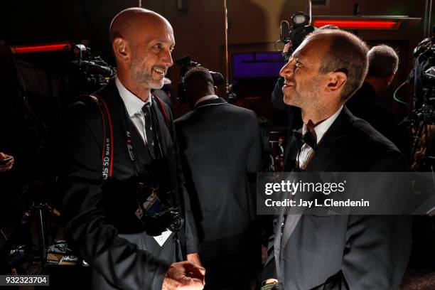 Photographer Alex Berliner, left and Mario Anzuoni, senior staff photographer with Reuters News Pictures, talk outside the Governor's Ball of the...