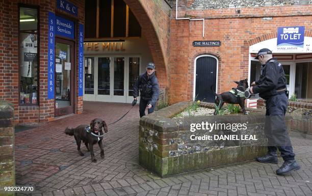 British police dog handlers work with their sniffer dogs outside The Mill pub in Salisbury, southern England, on March 15 as investigations and...