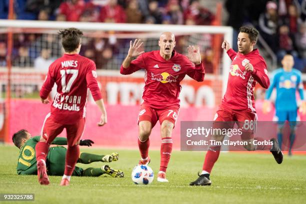 March 10: Aurelien Collin of New York Red Bulls reacts watched by team meats Ben Mines of New York Red Bulls and Vincent Bezecourt of New York Red...