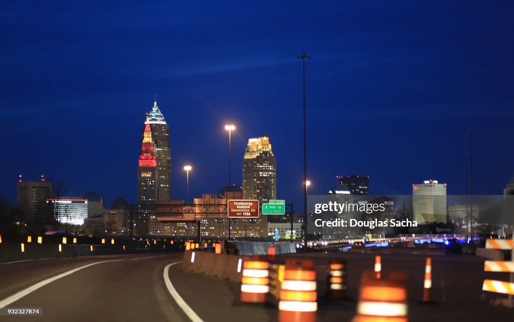 Approaching the cleveland city skyline at night from Interstate 90 with construction traffic barrels