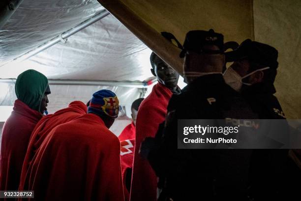 The Spanish Red Cross attending 48 migrants at the Harbour of Malaga on 14 March 2018 in Malaga, Spain. Late in the afternoon, 48 migrants among them...