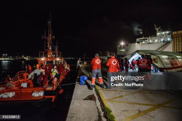 The Spanish Red Cross attending 48 migrants at the Harbour of Malaga on 14 March 2018 in Malaga, Spain. Late in the afternoon, 48 migrants among them...