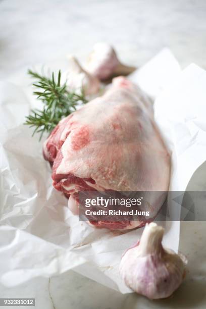 fresh leg of lamb on white butcher paper still life. - butcher paper foto e immagini stock
