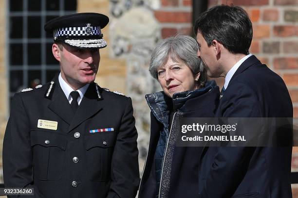 Britain's Prime Minister Theresa May talks with Wiltshire Police's Chief Constable Kier Pritchard as they walk near The Mill Pub in Salisbury,...