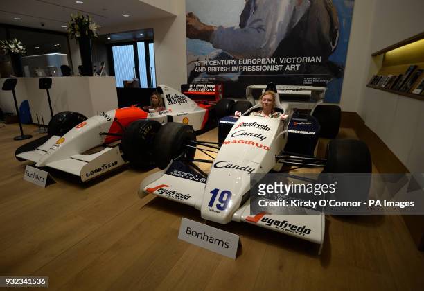 Bonhams employees sit in the 1984 turbocharged Formula 1 Toleman-Hart TG184 and the 1993 McLaren-Ford MP4/8A Formula 1 racer, driven by legendary...